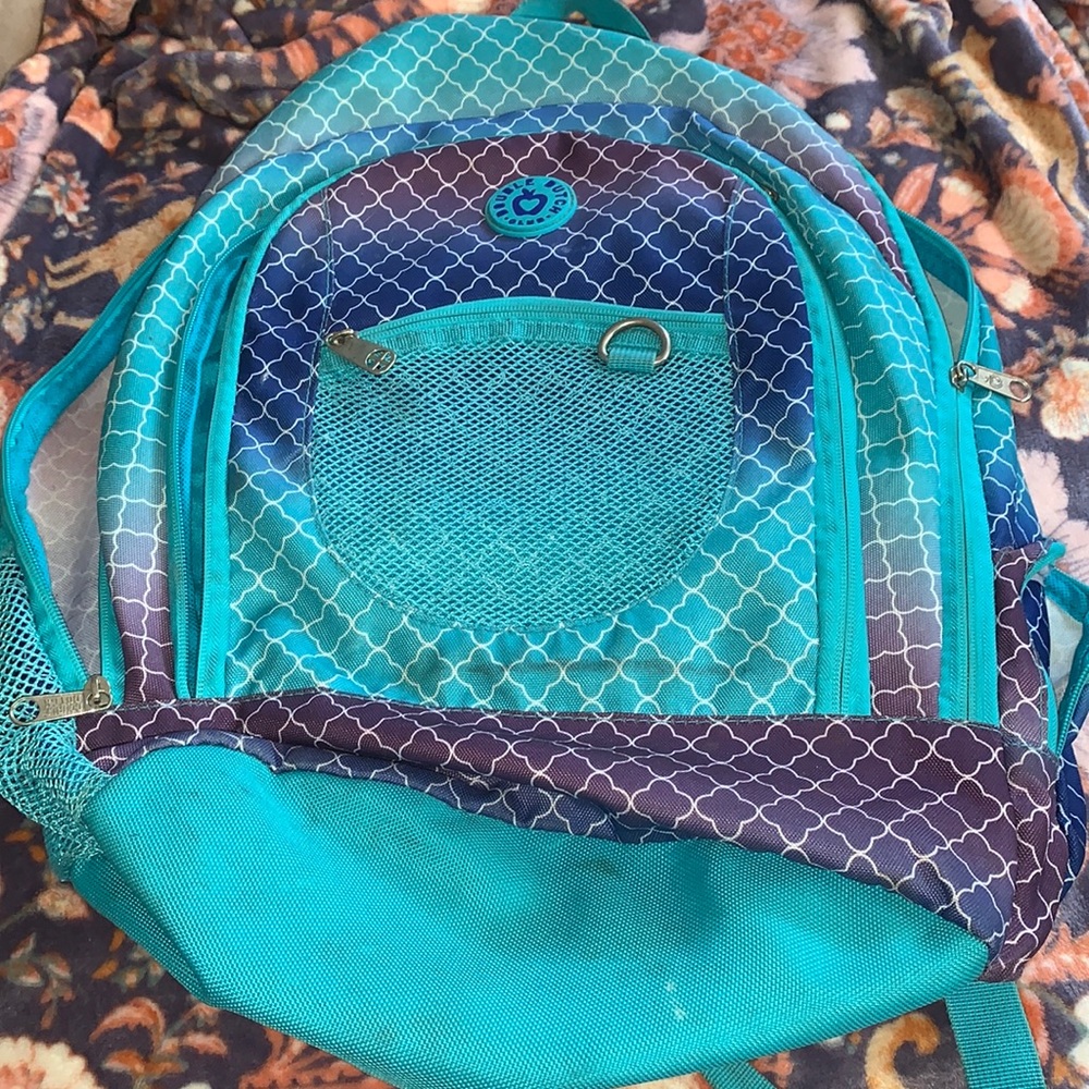 Blue, purple, and white. Girls backpack I used it for cheer for a year.